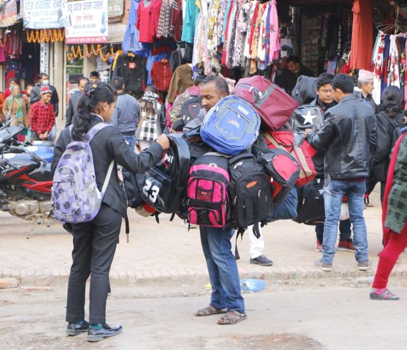 A student buying bag with a vendor in Lagankhel on Thursday. Photo: Pradeep Luintel/Aarthik Abhiyan