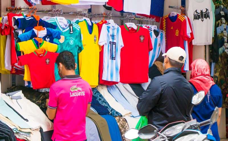 Football fans buying jerseys at a shop in Jamal in this recent photo. The sale of jerseys has increased significantly due to the ongoing World Cup. Photo: NBA