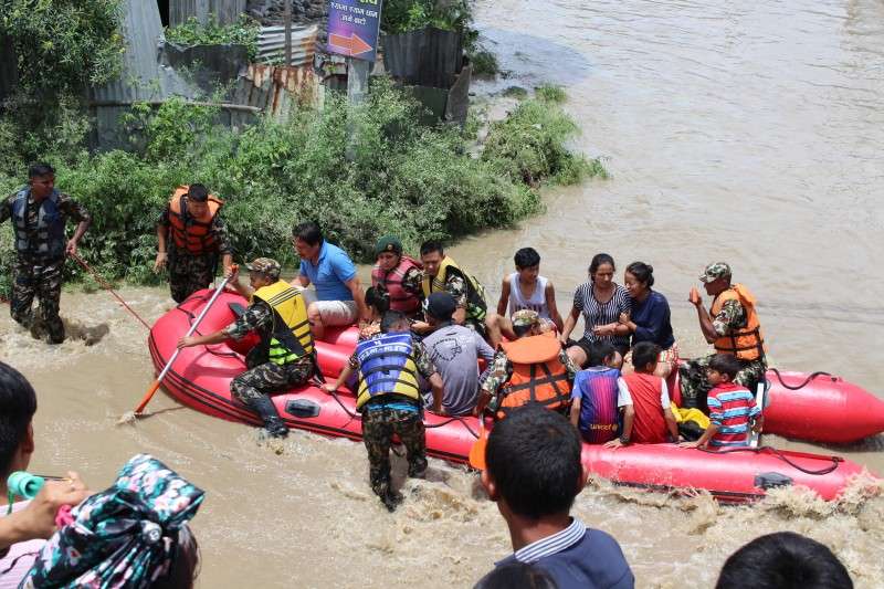 This handout photo provided by the Nepalese Army shows the army's rescue team evacuating locals of Bhaktapur affected by flood on Thursday. 