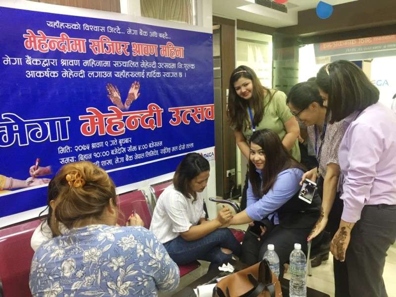 Mega Bank providing facility of free mehendi to its customers at its corporate office in Rising Mall, Durbar Marg on the holy month of Shrawan. Photo Courtesy: Mega Bank