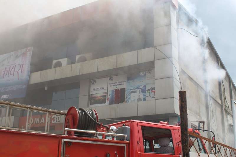 Smoke billows from the building of OMax Cinema Hall in Hetauda on Wednesday morning as a fire engine tries to control the situation. The cinema hall reported loss worth Rs 30 million due to the fire. Photo: Bhanubhakta Acharya/NBA