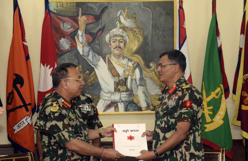 This handout photo provided by the Directorate of Public Relations of the Nepalese Army shows Chief of Army Staff (CoAS) Rajendra Chhetri (L) handing over the responsibilities of acting army chief to Lt Gen Purna Chandra Thapa on Saturday. CoAS Chhetri has taken one-month leave from office before his retirement. 