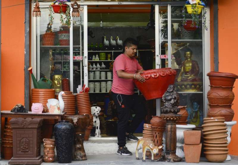 A shopkeeper displaying plastic pots and handicraft items at his shop in Sanepa, Lalitpur. According to the local businessmen, the products made in Bhaktapur have high demand in Lalitpur. Photo: Ravi Maharjan/NBA