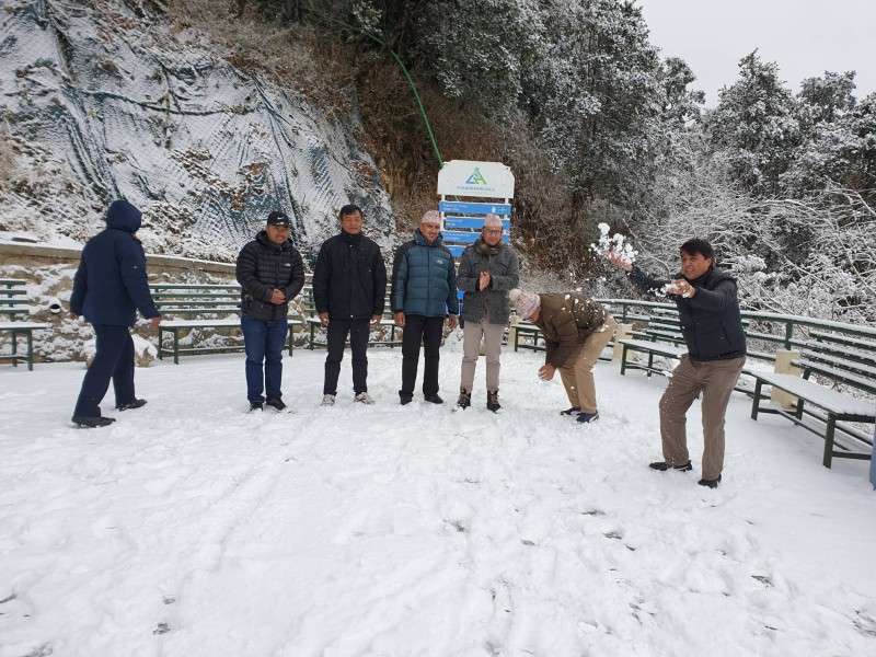 Chairman of Chandragiri Hills enjoying snowfall with co-workers in Chandragiri on Monday. Photo Courtesy: Raju Poudel