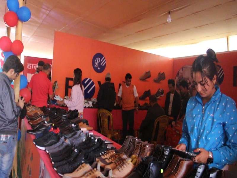 A visitor looking at shoes during the first day of Birat Footwear Expo in Biratnagar on Wednesday. The month-long expo is being organised to promote domestic products. Photo: NBA
