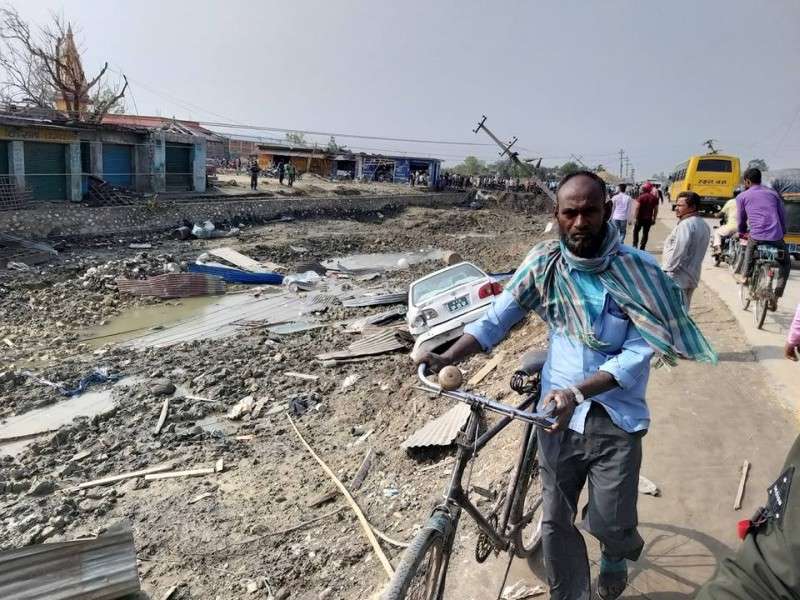 Debris caused by a storm lay scattered on Monday as a man walks with his bicycle in Bara district a day after the storm killed a dozens of people. Photo: Om Prakash Khanal/NBA